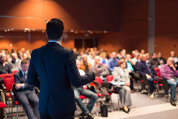 Back of someone presenting, the crowd is blurred